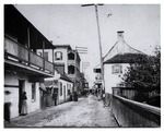 St. George Street just South of the intersection with Cuna Street, with the Ortega House the immediate left, followed by the Benet Store, and the Columbia Hotel (three story wooden structure with balconies) on the Northwest corner of the Cuna Street intersection, and Benet House on the right, looking North, ca. 1893