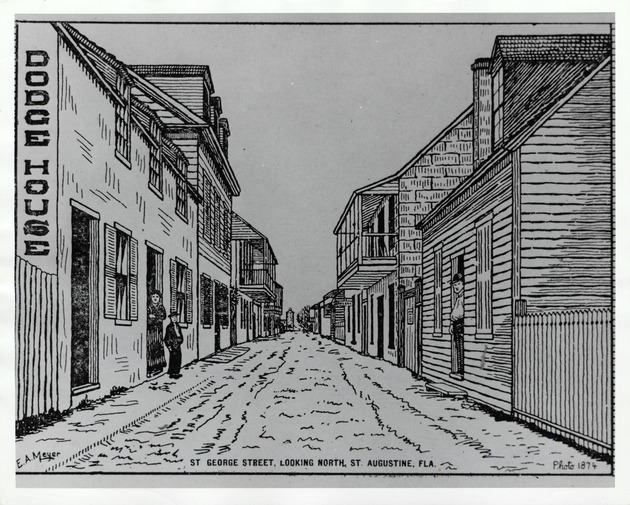 A photograph from a news publication showing St. George Street from in front of the De Mesa Sanchez House (on right, with sign as the "Waddill House") looking North, with the Arrivas House on left (with balcony), ca. 1900[?]