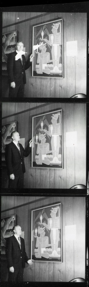 Man standing next to painting in Government House during the Contemporary Mexican Art exhibit, 1967