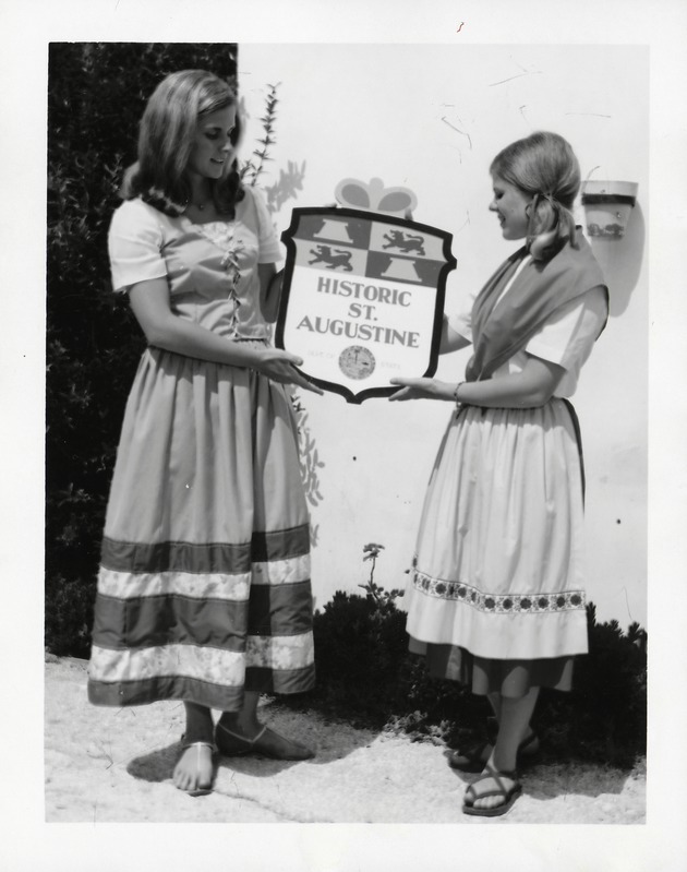 Sydney B. Raulerson (left) and Linda Dean (right) hold up a plaque for Historic St. Augustine, 1970