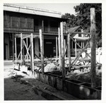 Construction of the Gallegos House with a wooden forms for pouring tabby walls with Parks Hotel and residence in the background, looking Northwest, 1962
