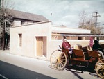 A Woman in horse-drawn carriage on St. George Street in front of the newly constructed Gallegos House, looking Northeast, ca. 1963