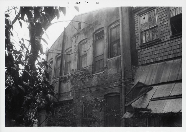 Rear of the structure on the Peso de Burgo property prior to demolition with a view of the roofline and the Southeast corner of the structure, looking Southwest, 1973