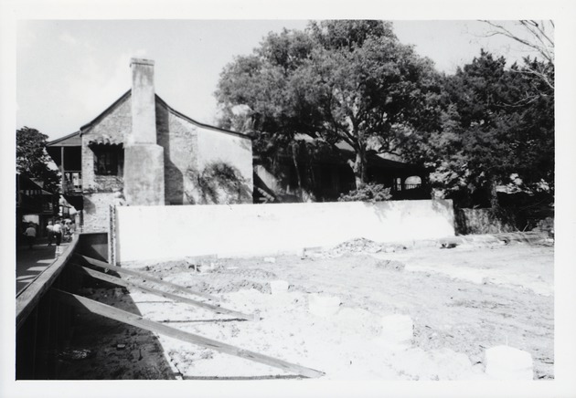 The cleared lot with foundation piers laid out just prior to the construction of the Peso de Burgo House looking North down where St. George Street borders the western edge of the property (De Mesa Sanchez House visible in the background), 1973