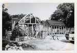 Framing the North and South outbuildings behind the Peso de Burgo House during construction, looking Northwest, 1973