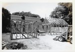 A team of workers constructing the frame of the South outbuilding behind the Peso de Burgo House, looking West, 1973