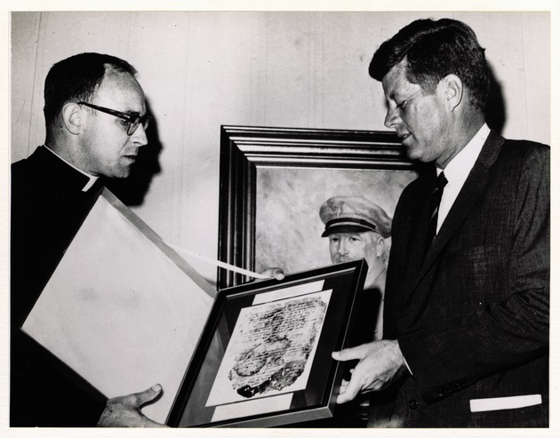 Dr. Michael Gannon presents President John F. Kennedy with a framed copy of the oldest writted record from St. Augustine (1565) at MacDill Air Force Base in Tampa, Florida, November 18, 1963