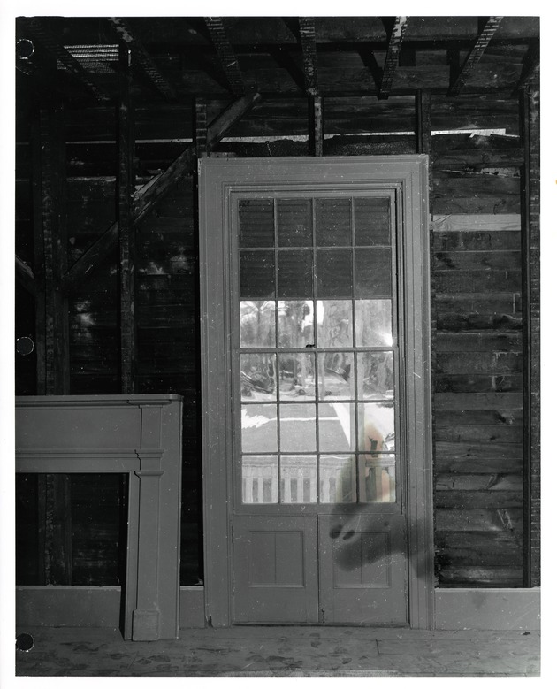 Interior view of a door to a balcony on the second floor of the Peña-Peck House during restoration work, looking South, 1968