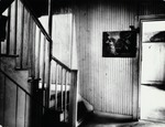 Interior staircase and artwork on the wall of the De Mesa Sanchez House, ca. 1955