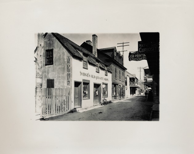Historic View of the Parades Dodge House as Dodge's Old Qriosity Shop with a bicycle in front, looking Northwest