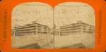 A stereoview of the bank on the corner of Cathedral Street and Charlotte Street, as seen from the basin, looking Northwest, ca. 1910