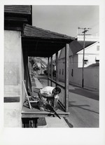 Billy Sanchez working on the Balcony of the Tovar House, looking East, 1960
