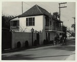 A horse-drawn carriage in front of the Llambias House on St. Francis Street prior to restoration work, looking Southwest