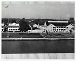 Photograph of a post card of the St. Francis Barracks, parade grounds, and officers quarters (left) with National Guard troops in formation on the parade ground, looking West, ca. 1970