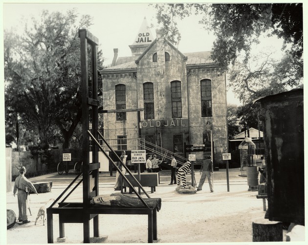 View of the side yard of the Old Jail with exhibits set up, ca. 1970