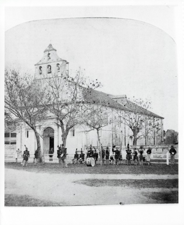 The Cathedral with a band relaxing in front, as seen from the Plaza de la Constitucion, looking Northwest, ca. 1871