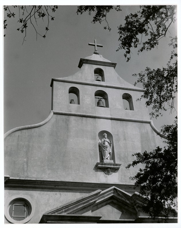 The bells in the parapet of the Cathedral Basilica and a statue of Saint Augustine of Hyppo, looking North, ca. 1960