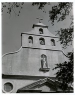 The bells in the parapet of the Cathedral Basilica and a statue of Saint Augustine of Hyppo, looking North, ca. 1960