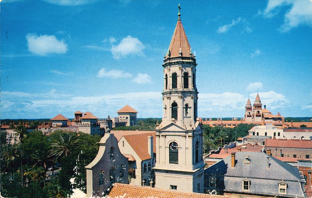 A postcard with a view of the roof and tower of the Cathedral Basilica with the towers of the Hotel Ponce de Leon and the Cordova Hotel in the background, as seen from the roof of the Exchange Bank Building, looking Southwest, ca. 1965 - Front