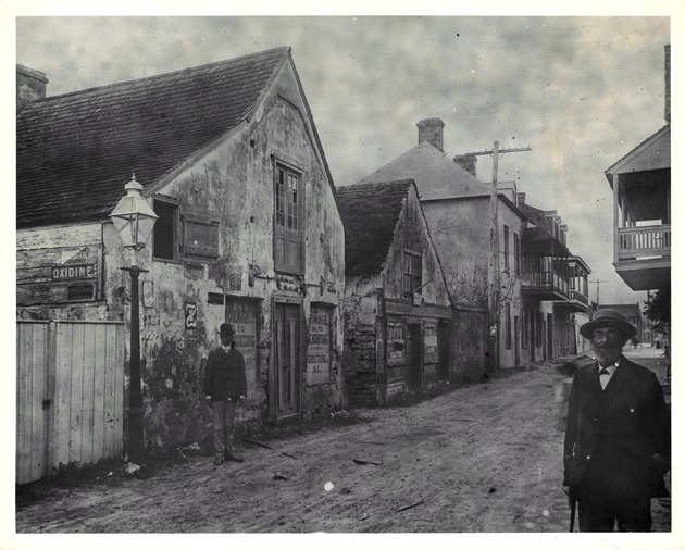 Two men standing along Charlotte Street at the intersection with Baya Lane, looking South, ca. 1888[?]
