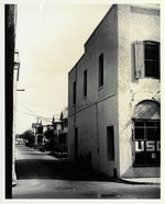 A view down Cuna Street from the intersection with St. George Street with the USO Building (prior to the reconstruction of the Benet House), looking East, 1962
