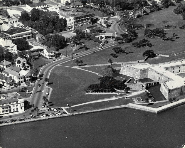 An aerial view of the grounds of the Castillo de San Marcos, the City Gate, and the north end of St. George Street, looking West, ca. 1960[?]