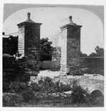 A young boy sitting on the wall of the City Gate, looking Southwest, 1871