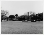 The City Gate, with the parking lot for the Oldest Wooden School House and the Milltop Tavern in the backgound (left), as seen from the grounds of the Castillo de San Marcos looking over Avenida Menendez (Bay Street), looking Southwest, ca. 1971