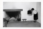 Salcedo Kitchen interior, woman baking bread in the traditional oven