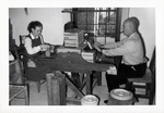 [1966] Salcedo House interior, man and woman making cigars