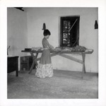 [1967] Salcedo Kitchen interior, woman wrapping trays of bread, looking North