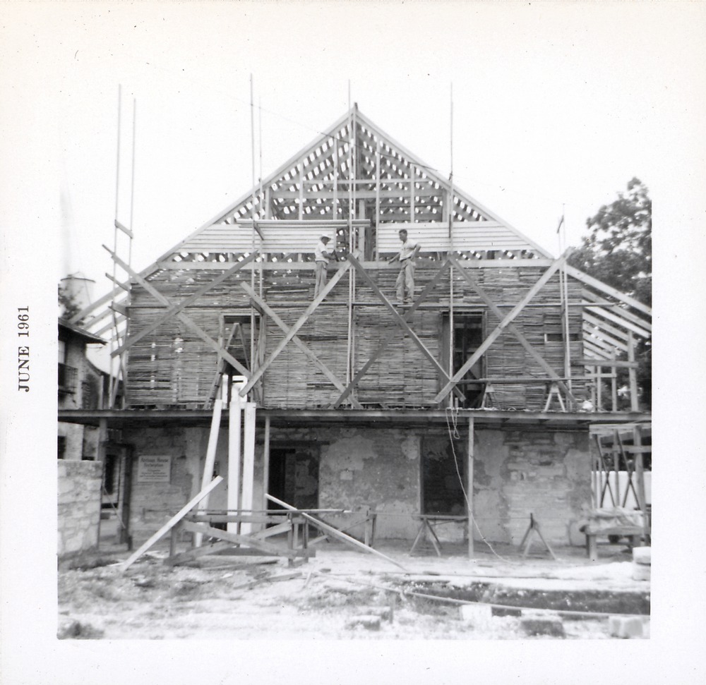 Cladding the northern gable of Arrivas House during restoration, looking South, 1961