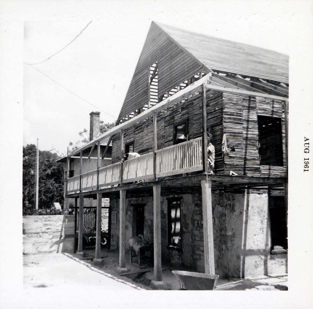 Installing the railing of the balcony on the north side of Arrivas House during restoration, looking East, 1961