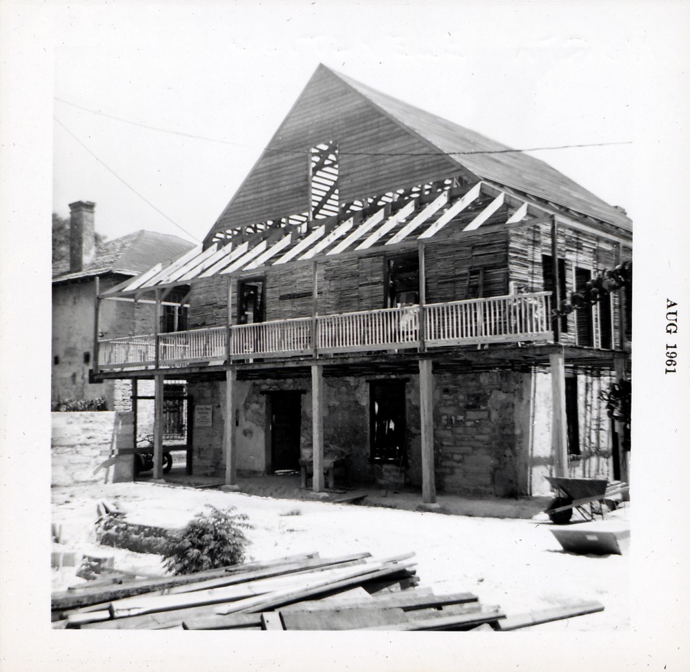 Northern elevation of Arrivas House during restoration, working on the balcony, looking Southeast, 1961