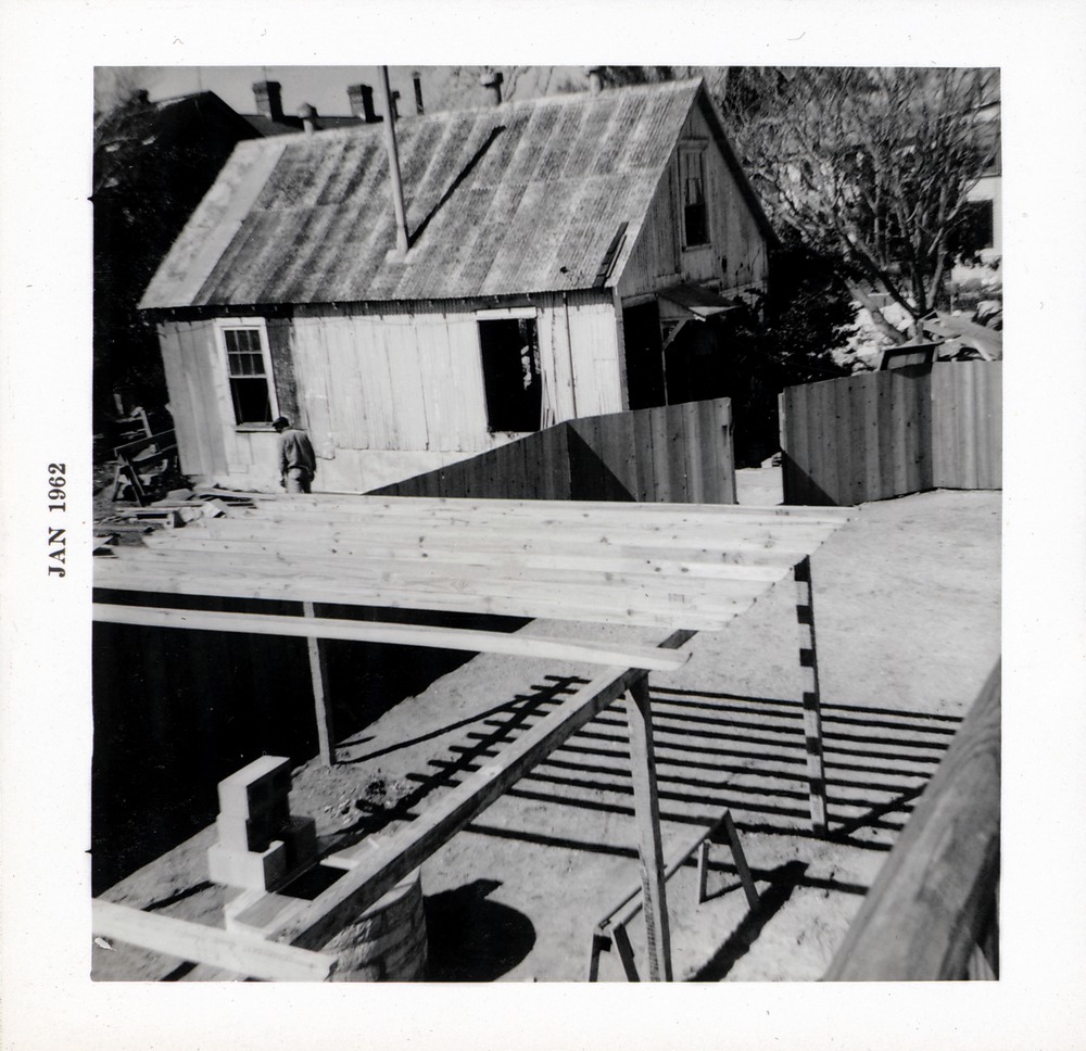 Constructing the grape arbor over the coquina well behind Arrivas House, from the balcony looking Northwest, 1962