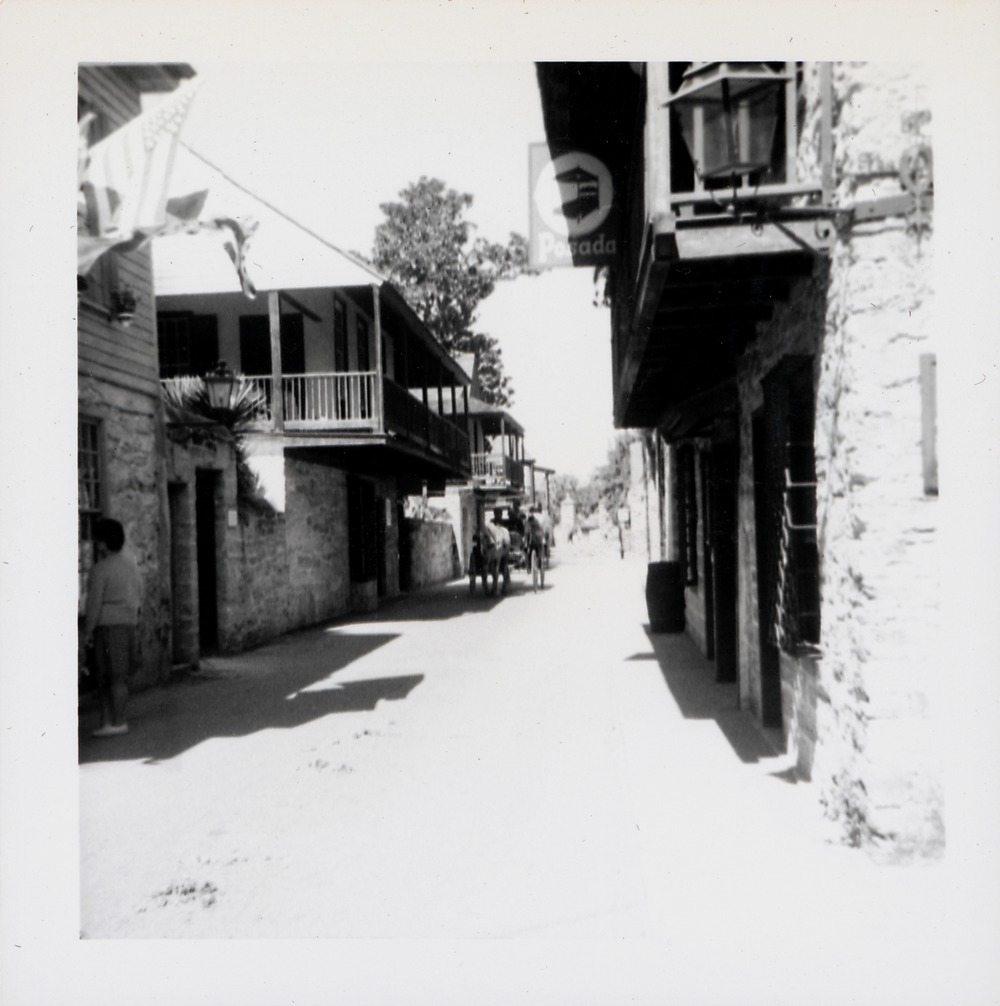 Arrivas House with a horse-drawn carriage out front and a view down St. George Street, looking North