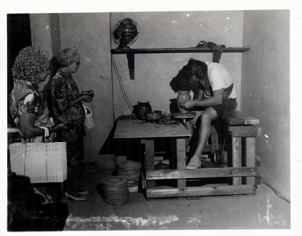 Two women watch Neal Jowaisas at work on the kick wheel in the Pottery Shop, 1969