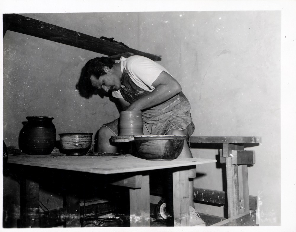 Neal Jowaisas working on kick wheel in the Pottery Shop behind Sanchez de Ortigosa House, 1969