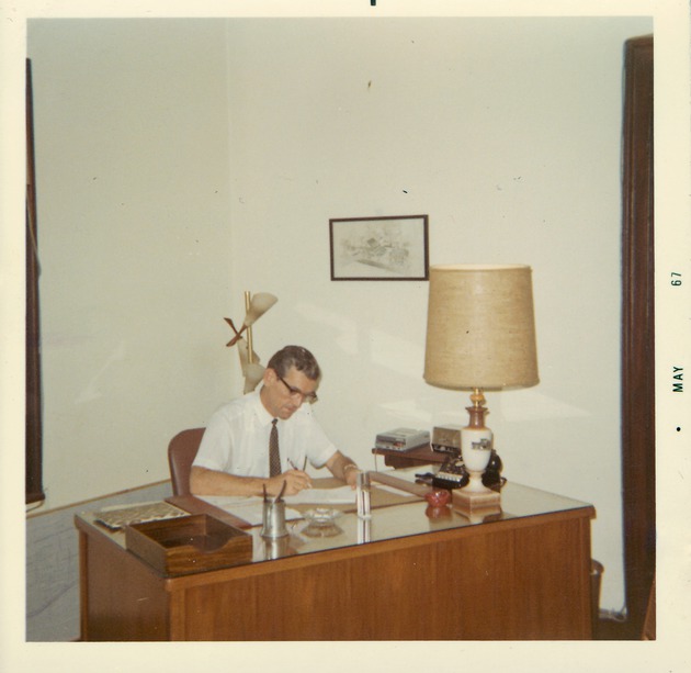 Bradley G. Brewer working a desk