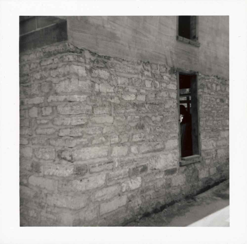 Views showing the coquina under the stucco on the first story of the Benet Store, July 1967 - 