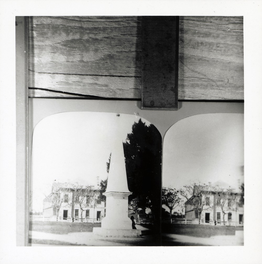 Photograph of stereograph image from the Boyd Collection (ca. 1870-1880) showing Government House behind the monument to the Spanish constitution, looking West