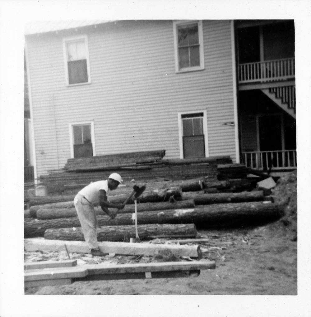 Hand-hewing log posts for the Old Blacksmith Shop - 