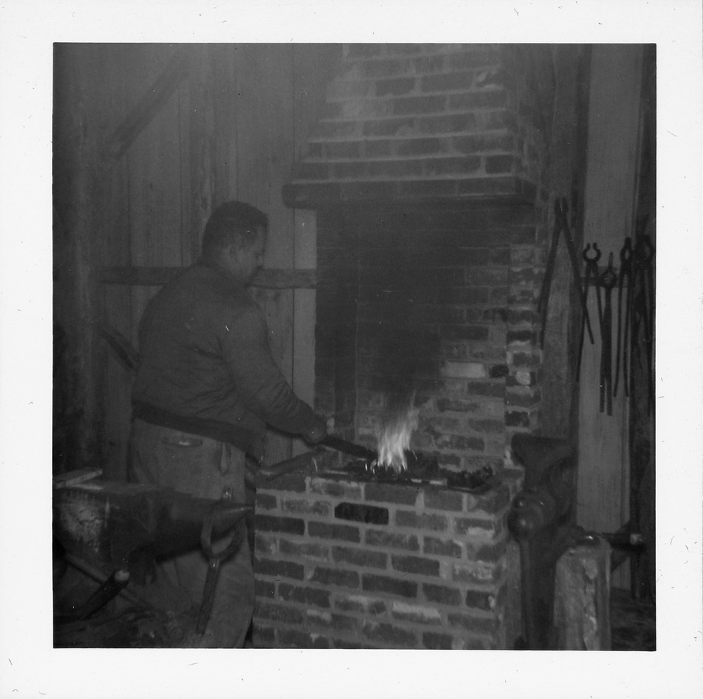 Coco Mickler heating up metal inside the Old Blacksmith Shop