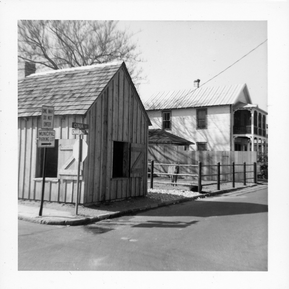 Old Blacksmith Shop from the corner of Charlotte Street and Cuna Street, with burro in the background, looking West