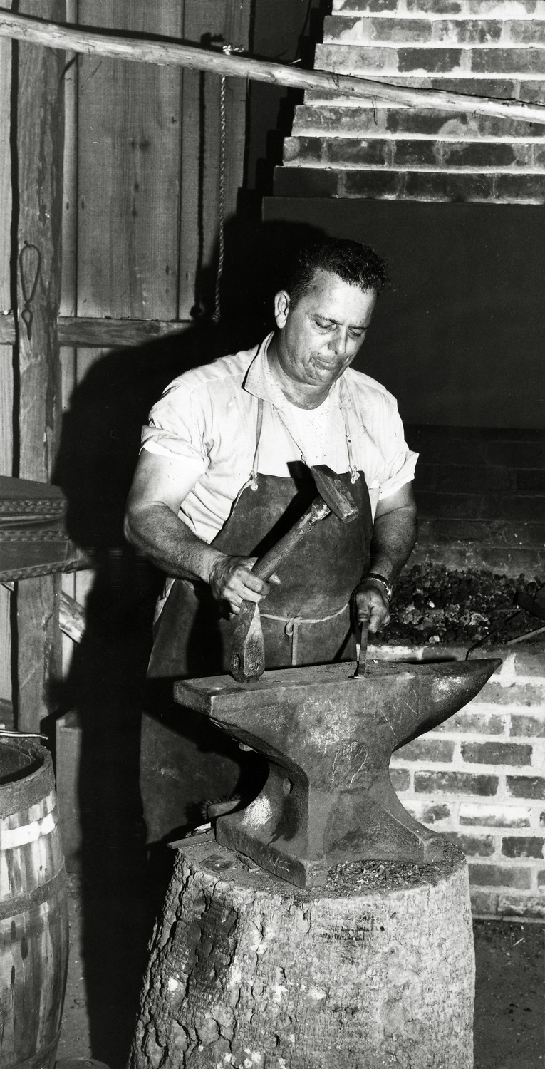 "Ring of Mickler's Hammer": Coco Mickler working in the Old Blacksmith Shop (photo for newspaper article) - 