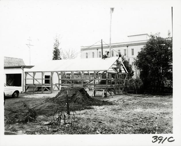 Construction of a greenhouse on the Brewster property from Cuna Street, looking South, 1969