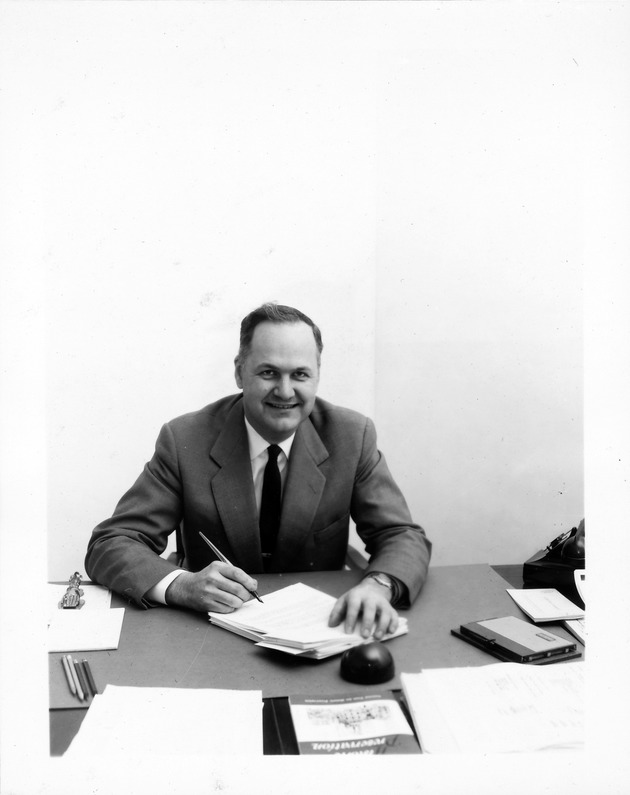 Earle Newton sitting at his desk