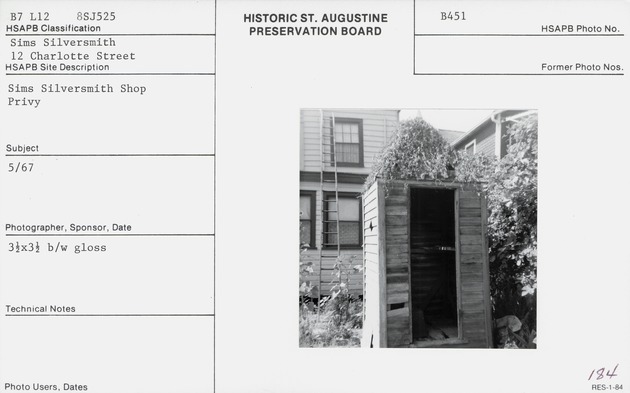 Looking into the outhouse (privy) in the rear yard of the Cerveau House, looking South, Cerveau House directly behind and Haas House on the right (card is mislabeled)