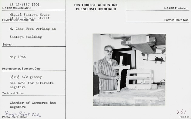 M. Chao showing showing a cross and a decorative shelf made in the Santoya House, looking South